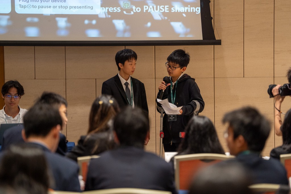 Two students presenting at podium