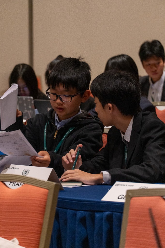 Two delegates reviewing documents at France–Germany tables